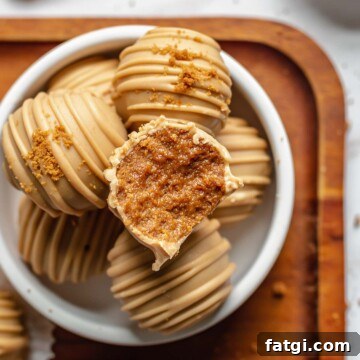 A bite removed from a biscoff truffle.