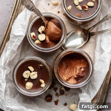 Nutella mousse cups on platter with spoons.