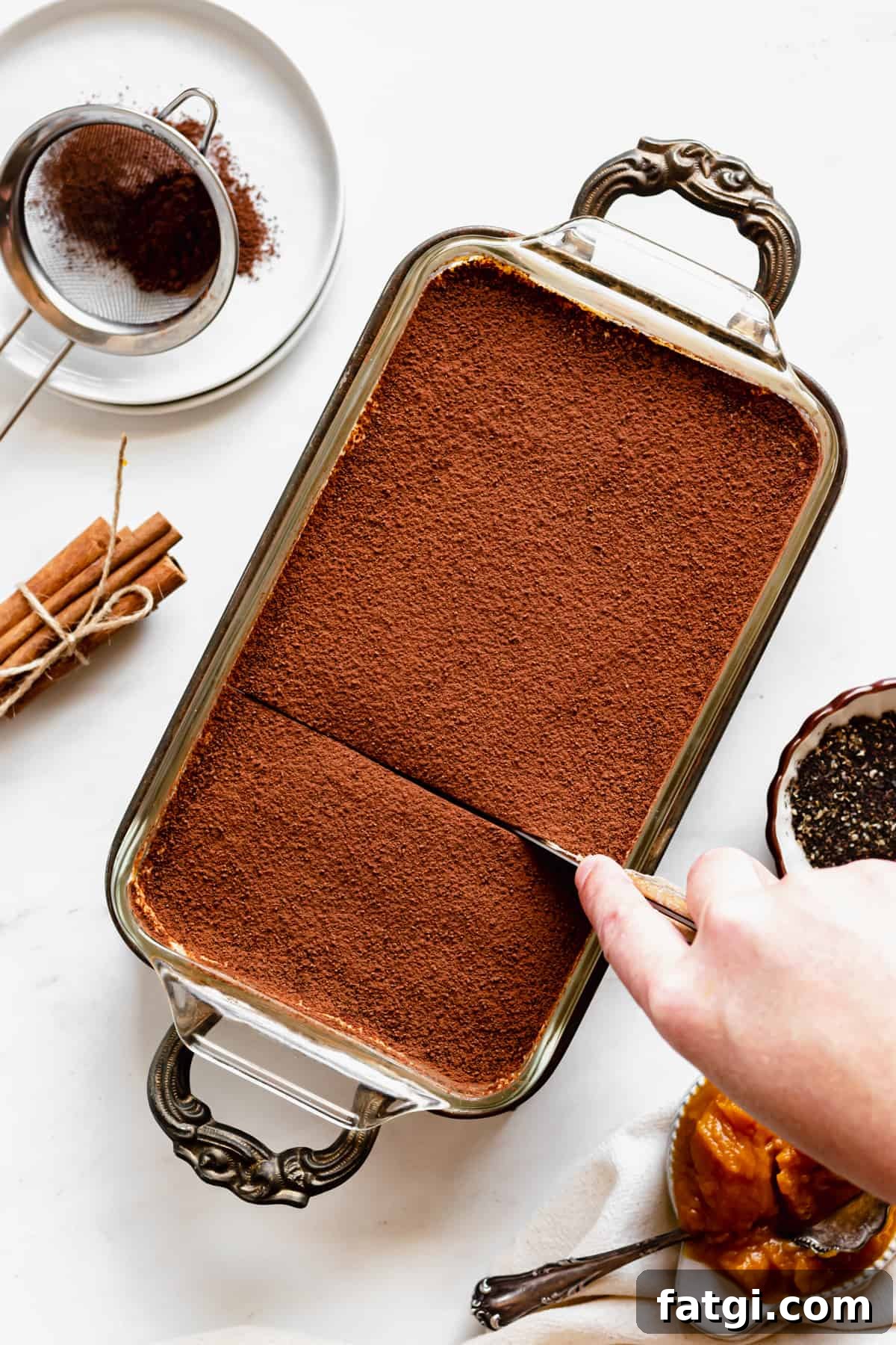Pumpkin Chai Tiramisu Recipe 10 A knife cuts into the pumpkin chai tiramisu.