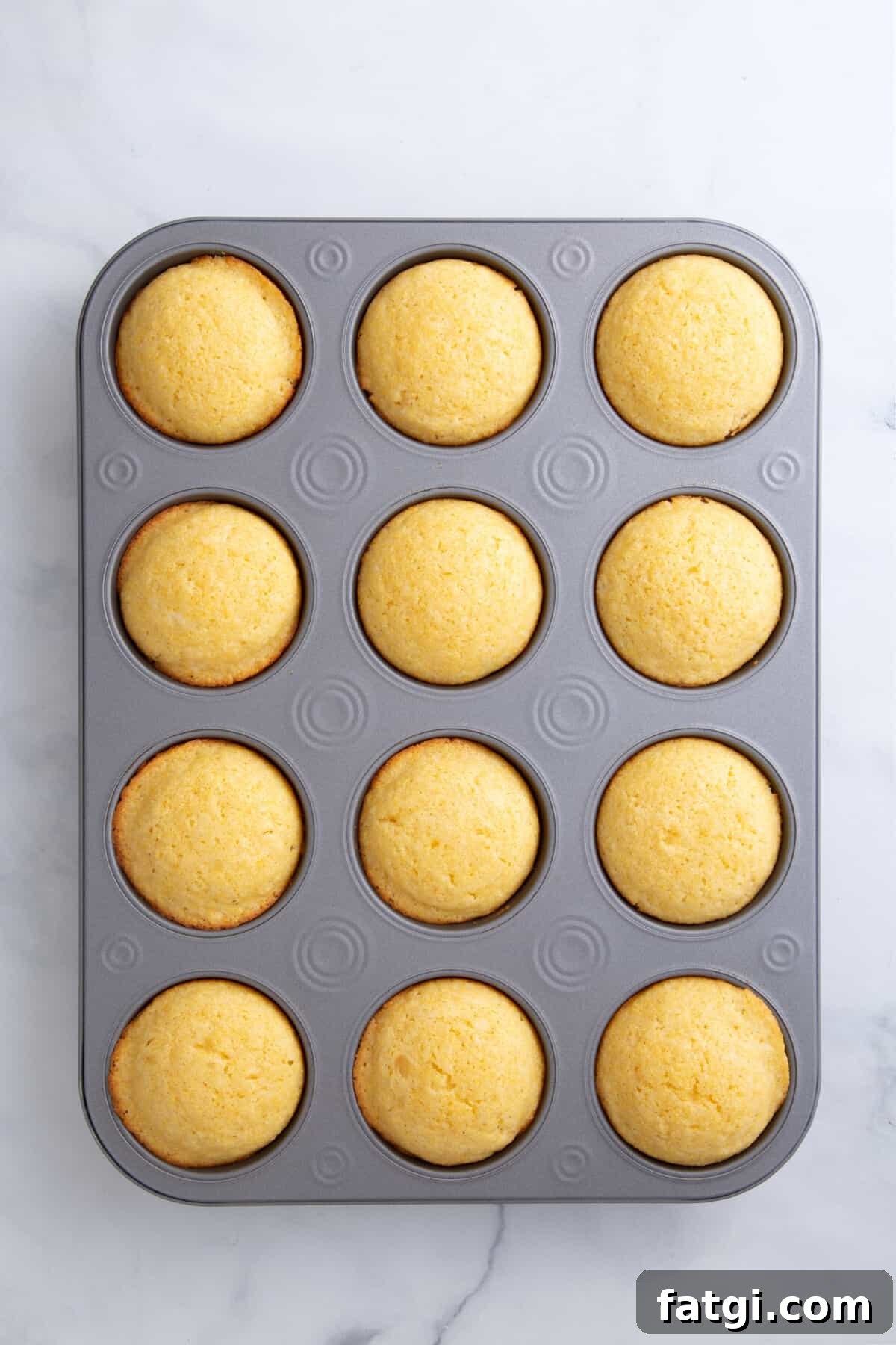 Homemade Corn Muffins with Honey Butter Recipe 7 baked corn muffin in a 12 count muffin tin.