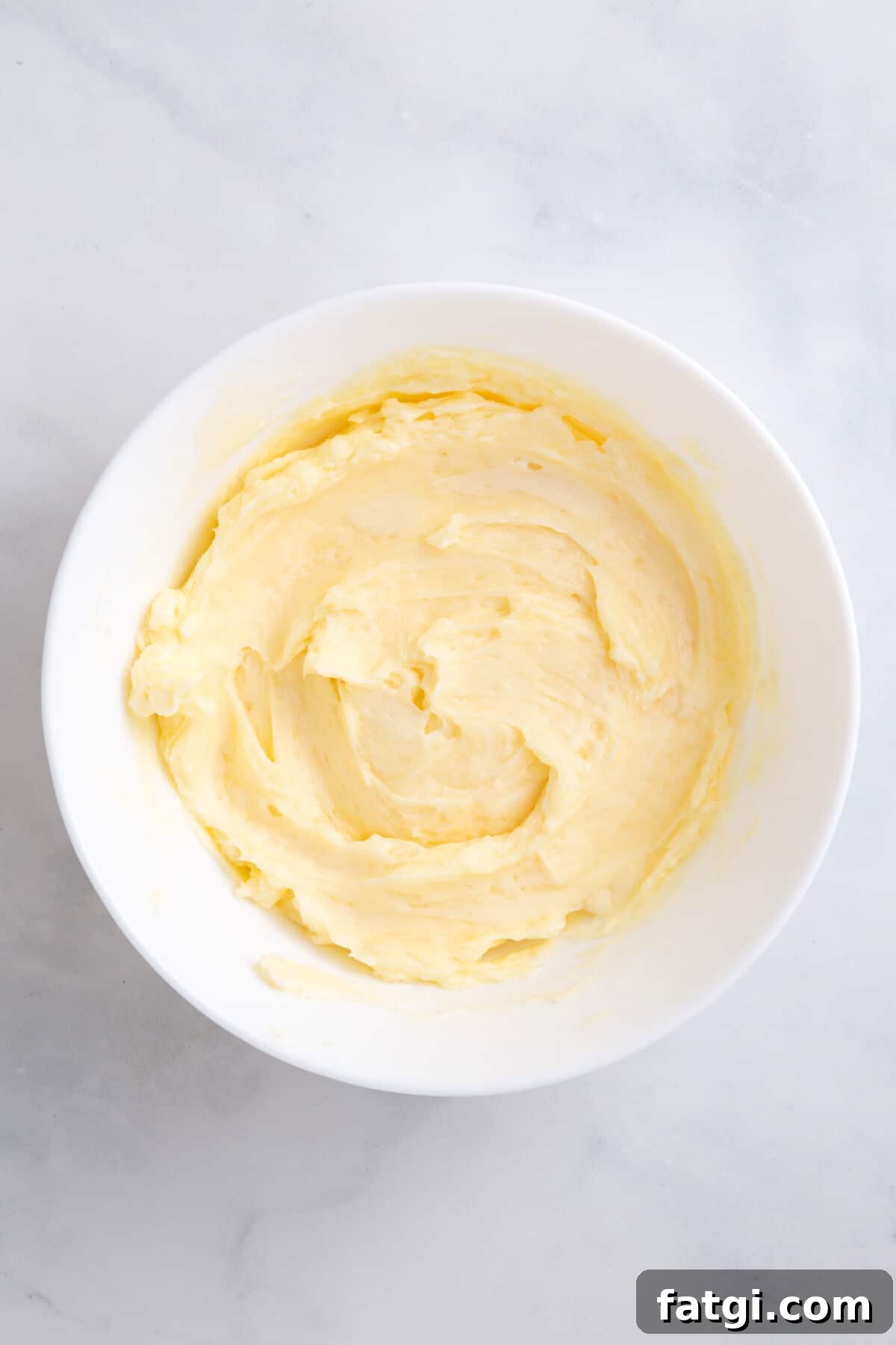 Homemade Corn Muffins with Honey Butter Recipe 8 honey butter in a large white bowl.