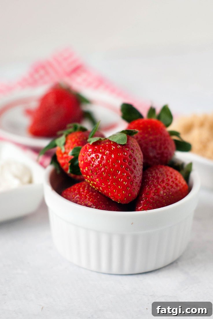 Strawberries with Sour Cream Classic Summer Dessert 2 A bowl of strawberries getting ready to dip in sour cream and brown sugar