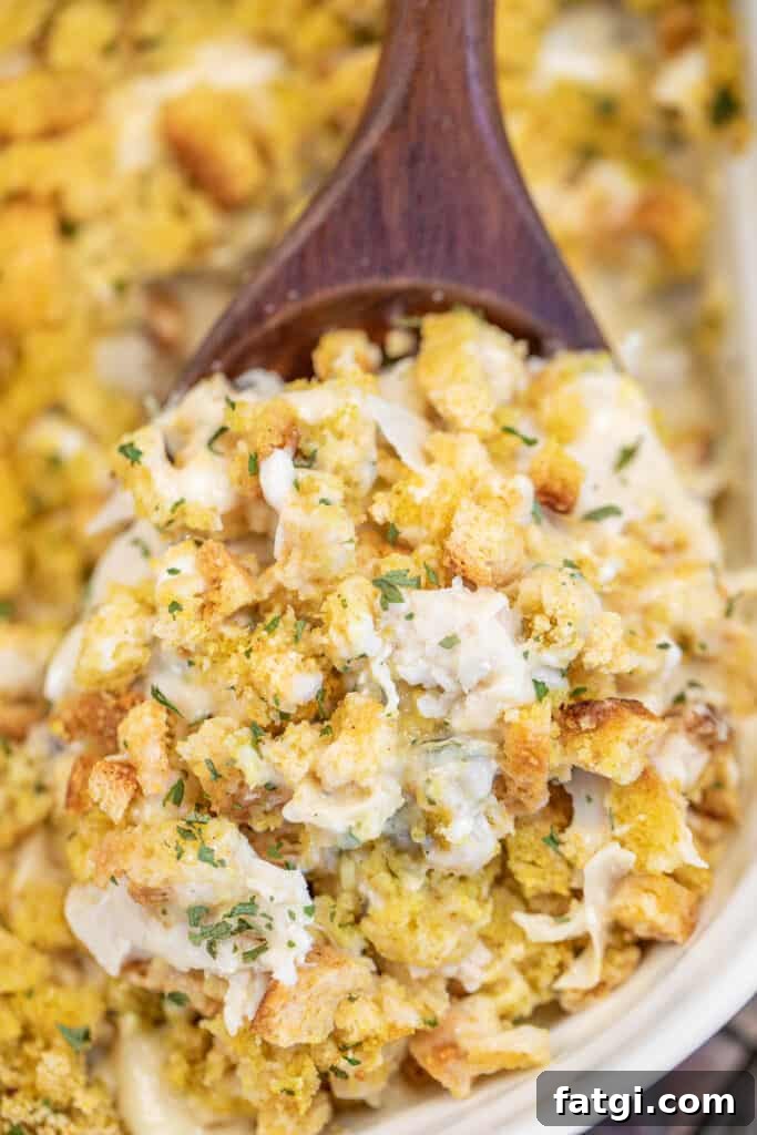 scooping chicken casserole from a baking dish