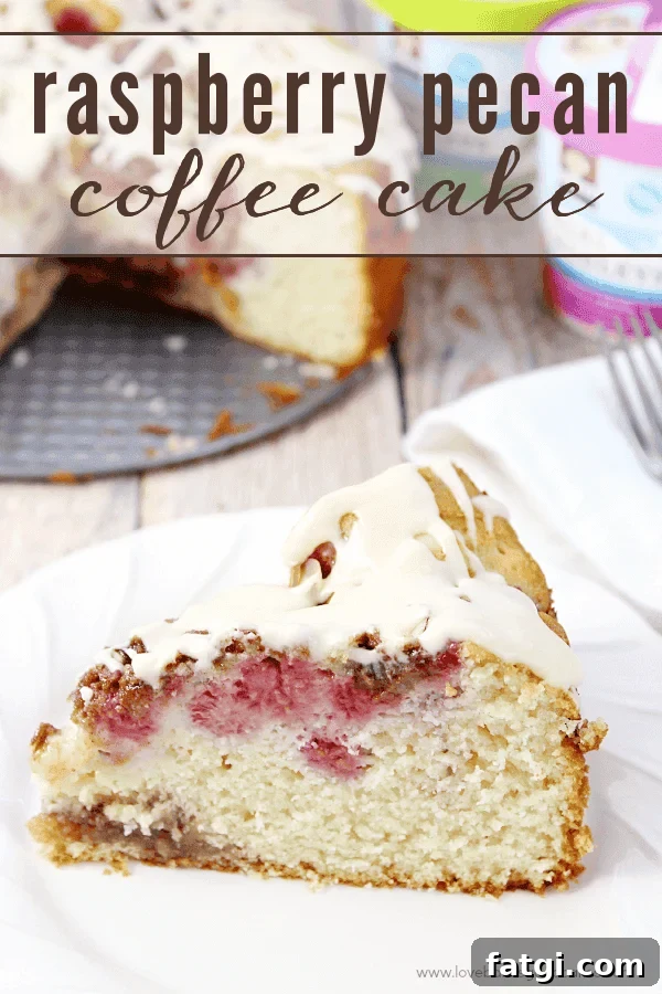 Raspberry Pecan Coffee Cake Recipe 2 Raspberry Pecan Coffee Cake on a white plate with a fork.