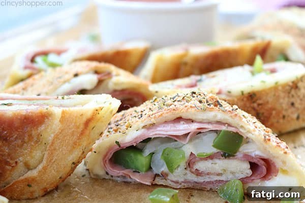Easy Stromboli - Since we use store bought pizza dough, it comes together in no time at all. Load in your favorite toppings like ham, salami, provolone, mozzarella, peppers, onions, the combinations are endless.
