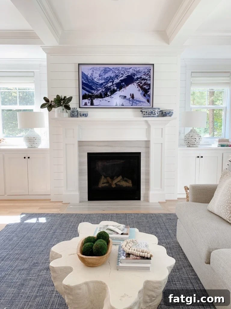 Samsung Frame tv 55" above a fireplace mantel in a living room