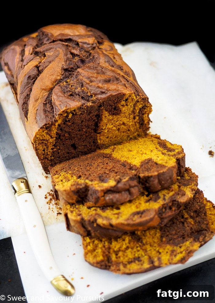 Sliced chocolate swirled pumpkin loaf.