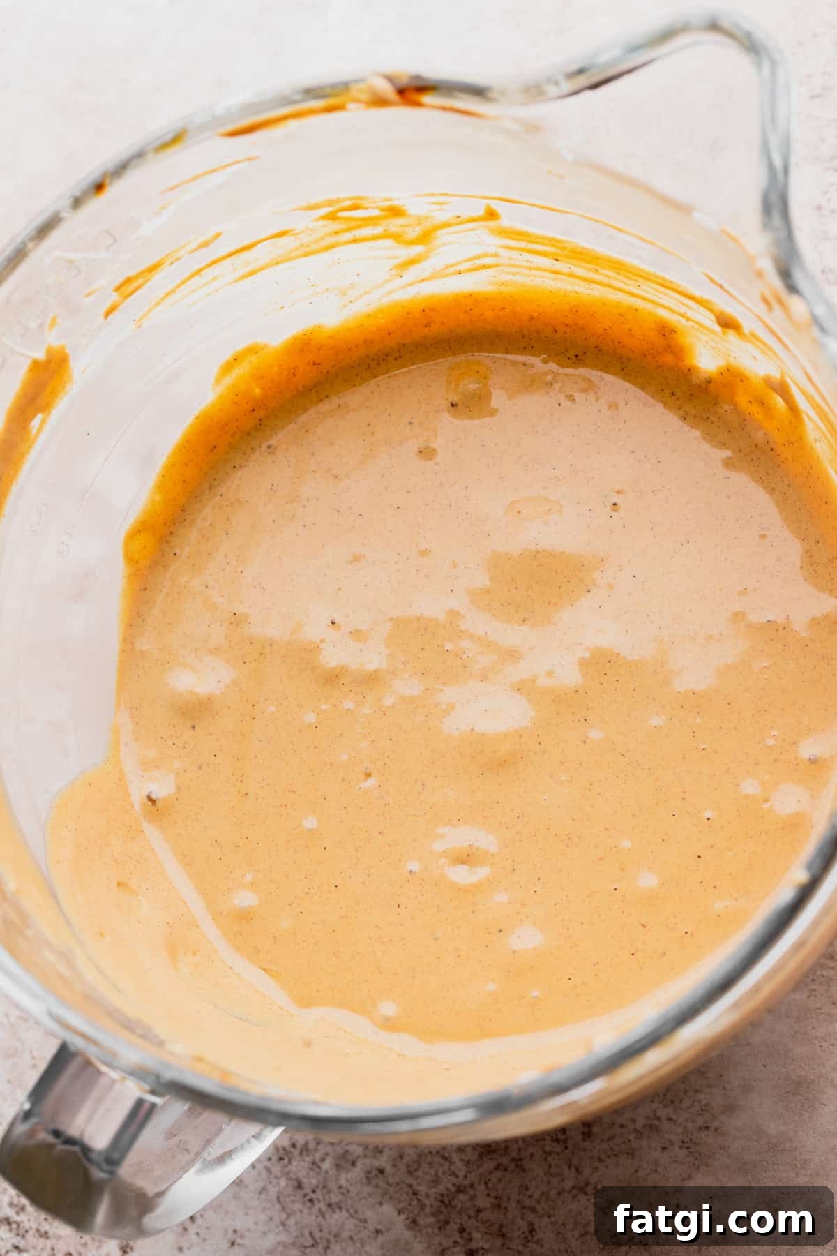 Cheesecake batter in a glass bowl.