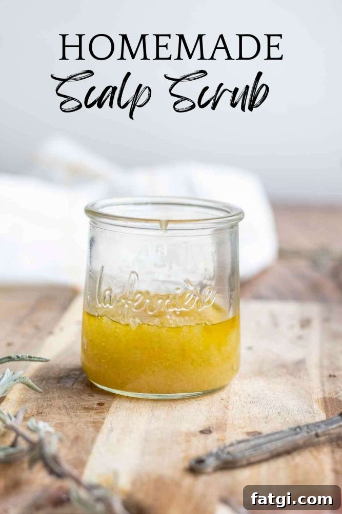 glass jar full of homemade scalp scrub on a wooden cutting board with a towel in the background