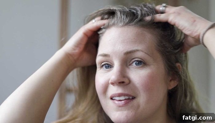 a woman rubbing a sugar scalp scrub onto her scalp