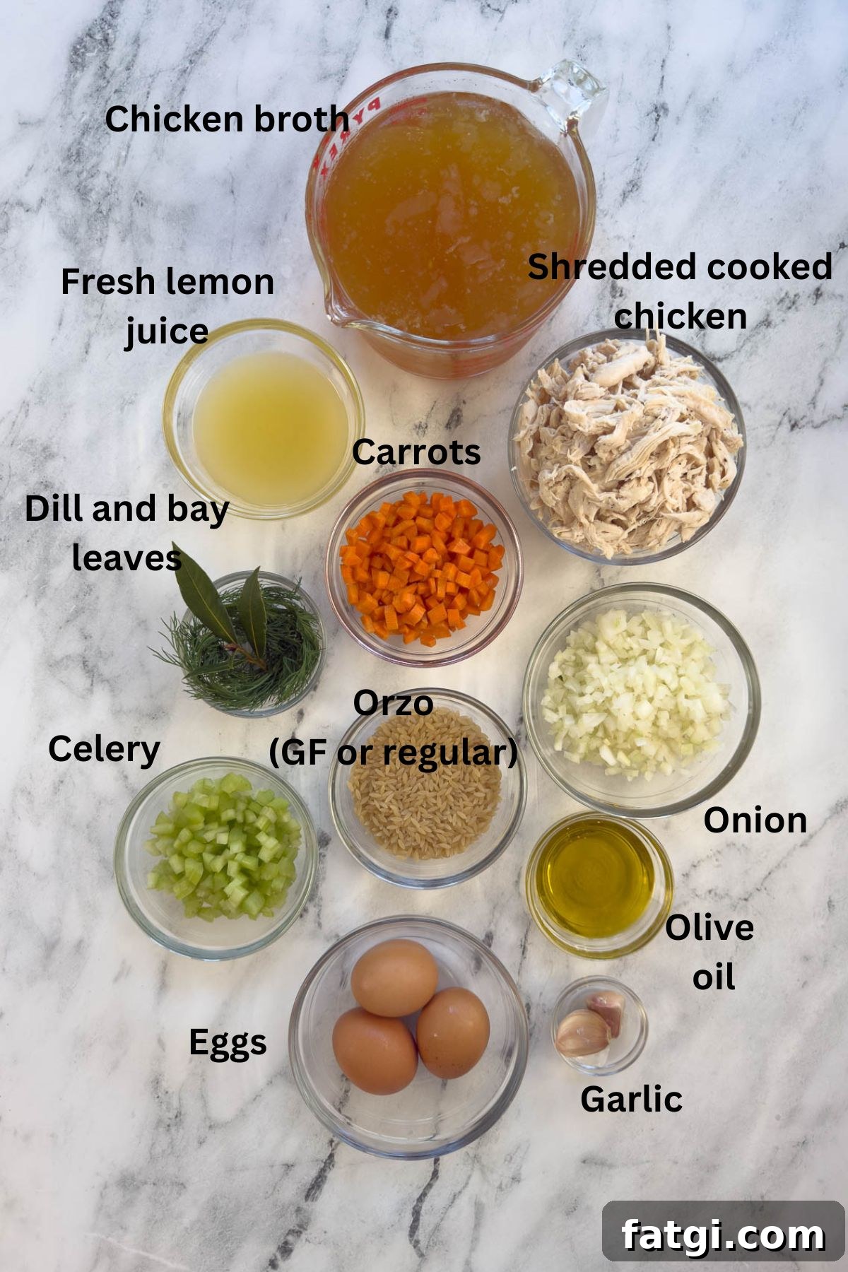 Ingredients for Greek avgolemono soup in prep bowls on the counter.