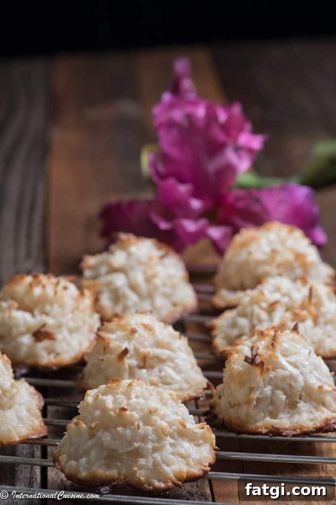 Panamanian Cocadas on a cooling rack with a purple orchid in the background