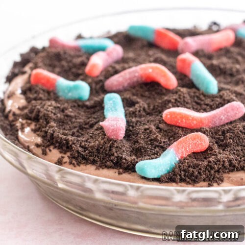 mud pie recipe with gummy worms shown close up in glass pie plate