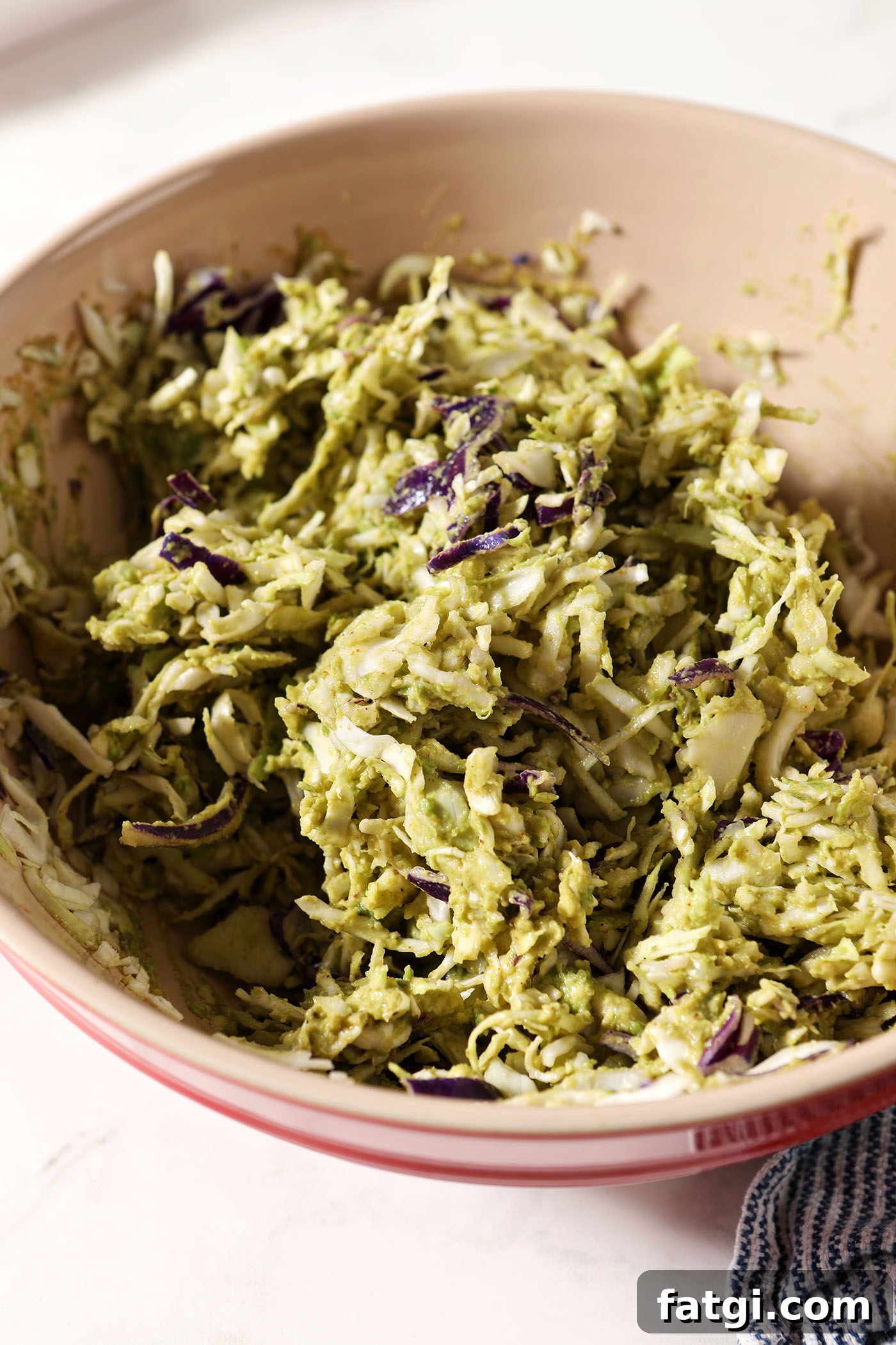 Avocado coleslaw in a bowl after mixing