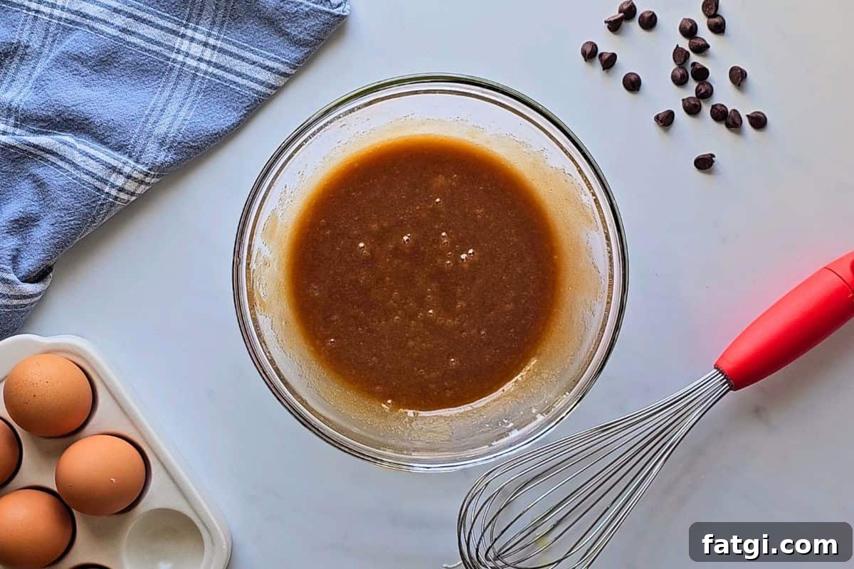 Melted butter whisked with brown sugar, white sugar, and egg.