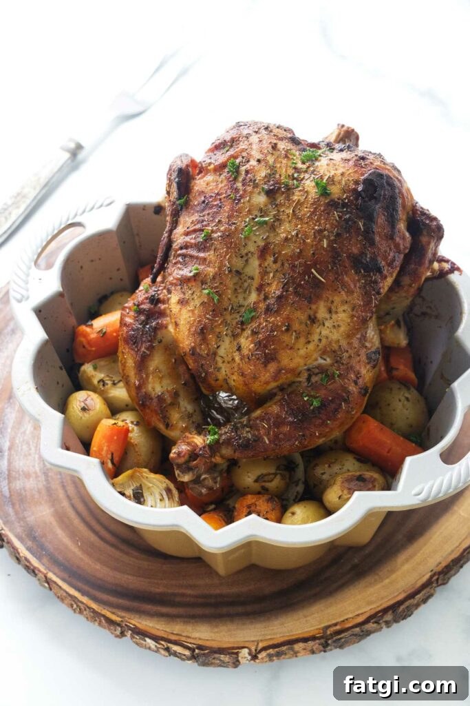 Herb Roasted Bundt Pan Chicken and Vegetables 2 Bundt pan with a roasted whole chicken and vegetables.