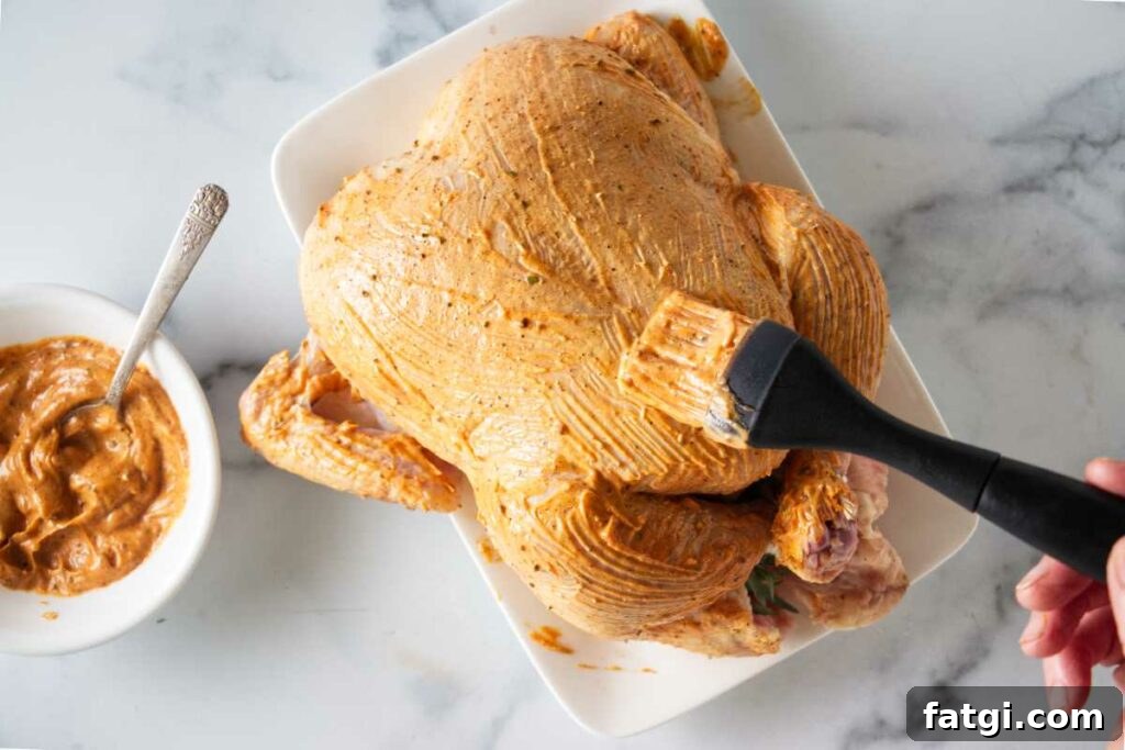 Herb Roasted Bundt Pan Chicken and Vegetables 7 Brushing the seasoning sauce on the chicken.