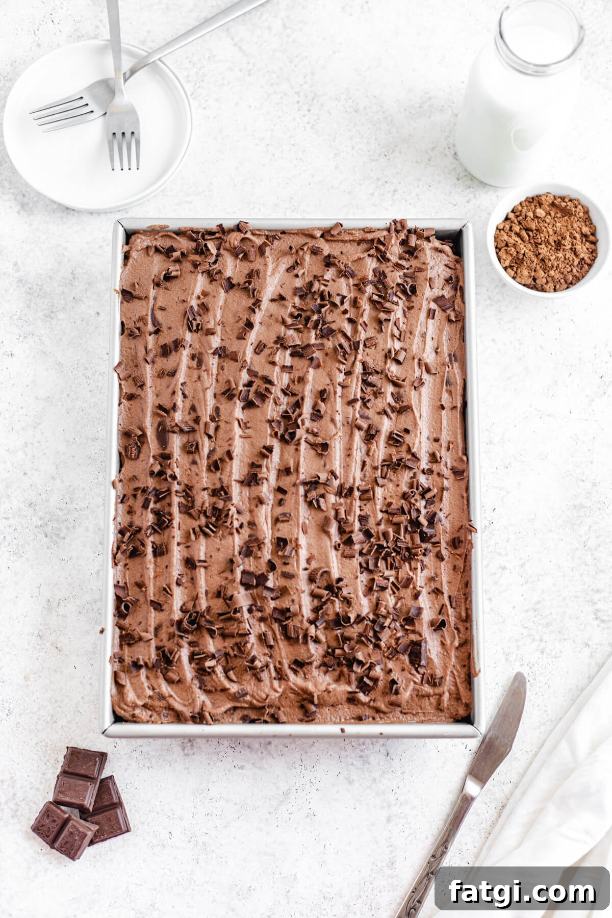 flat-lay of frosted chocolate cake in the rectangle pan 