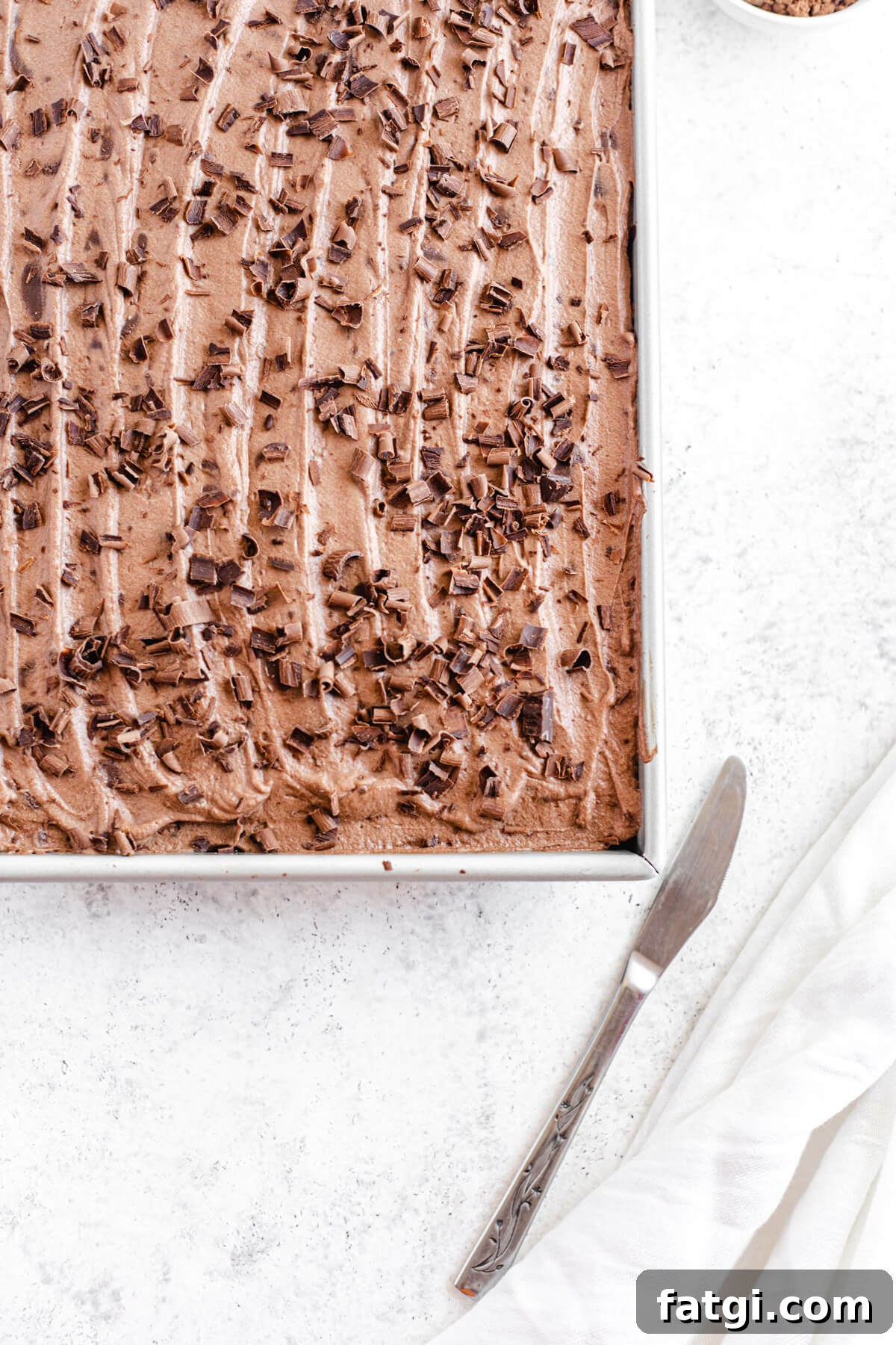 close up of mousse covered cake in a rectangular pan