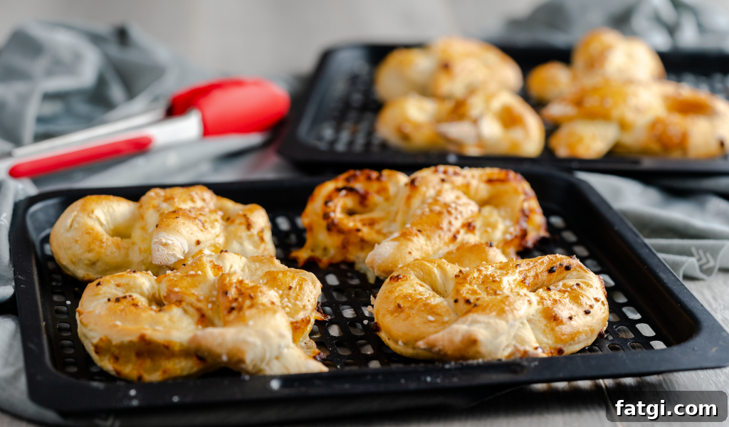 Air fryer rack with four garlic mozzarella pretzels.