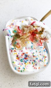 top view of spoon of birthday cake baked oats and ceramic white dish