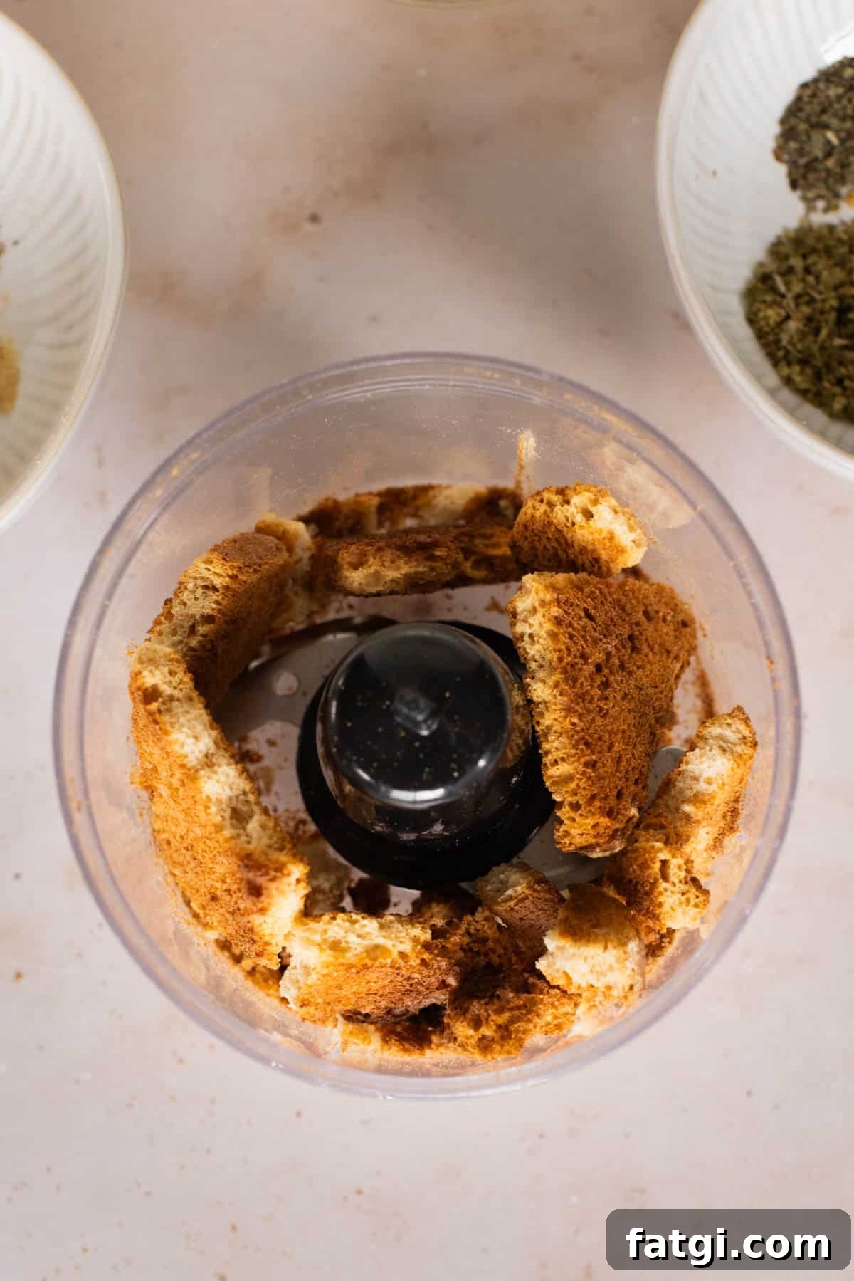 Toasted bread chopped in food processor.