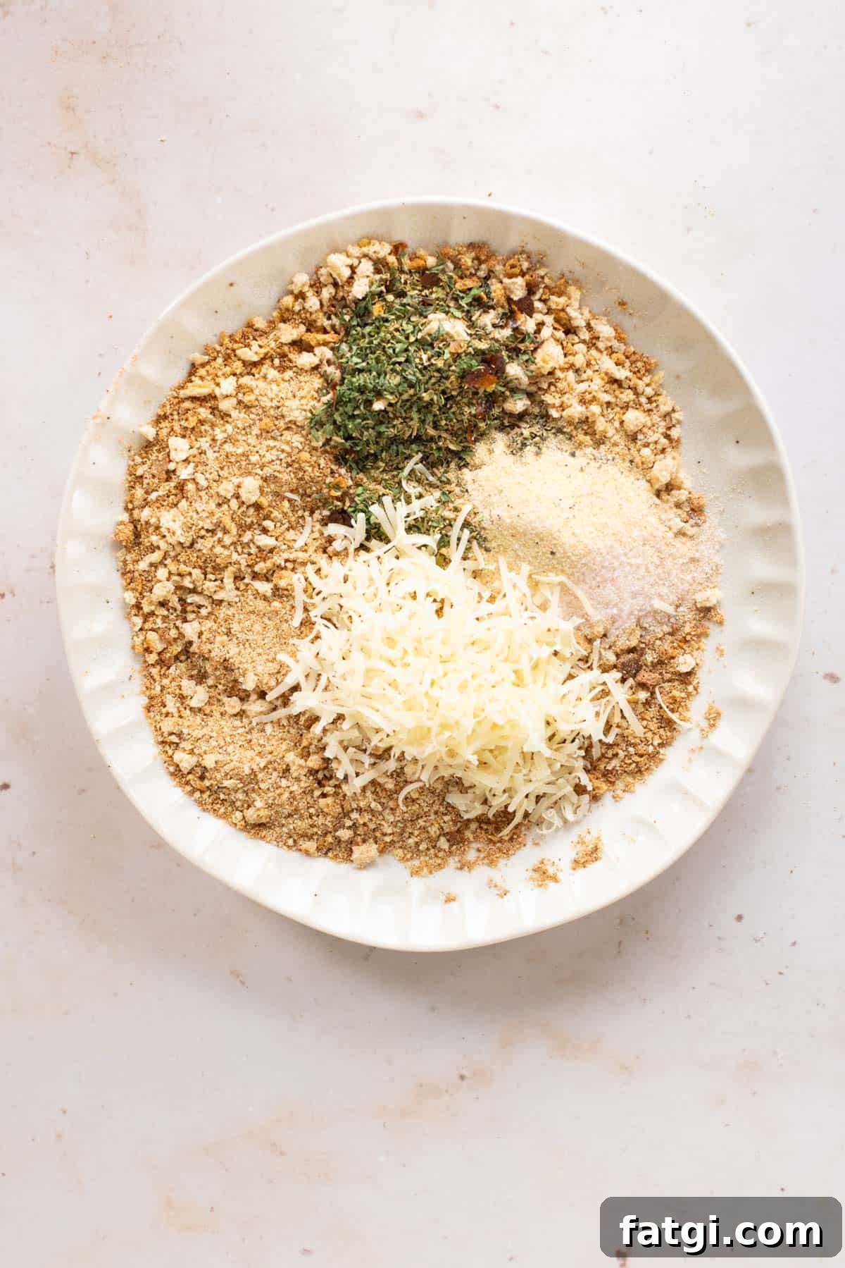 Breadcrumbs topped with spices and parmesan cheese.