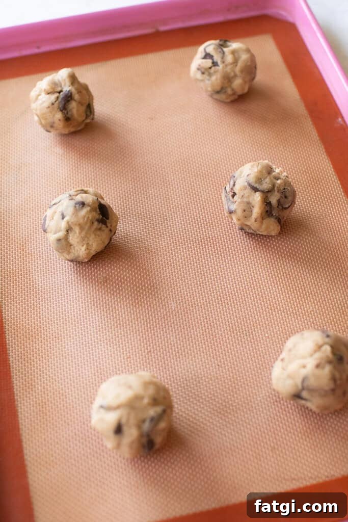 Brown butter cookie balls on a silpat.