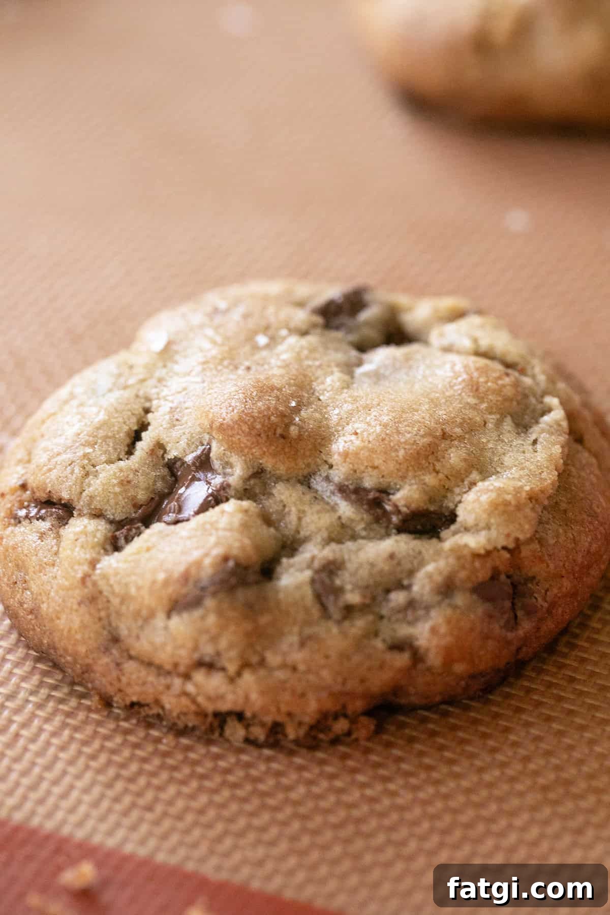 Brown butter chocolate chip cookie on a baking sheet.