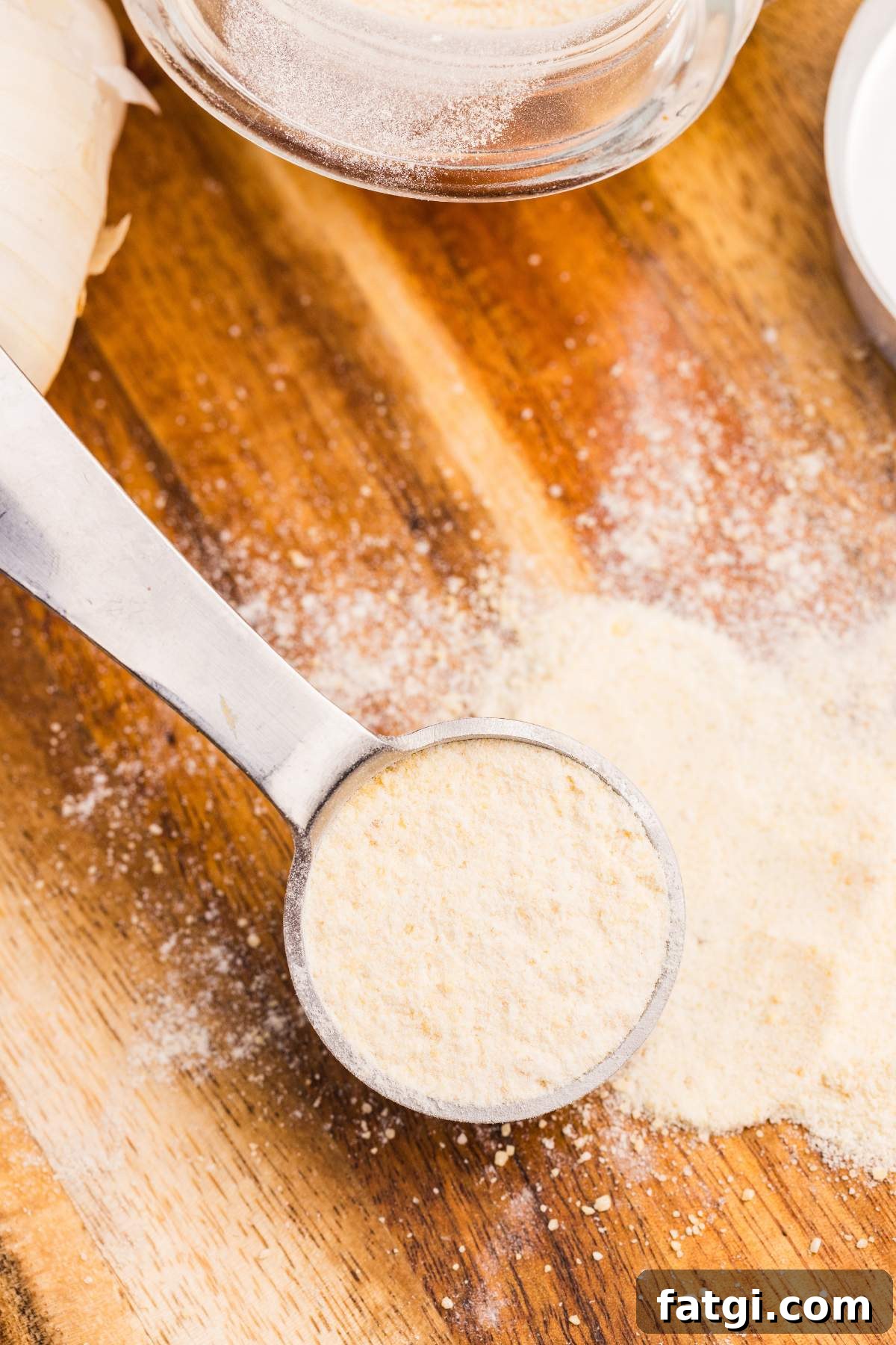 Make Garlic Powder at Home Using a Dehydrator 2 Jar of garlic powder on wooden board.